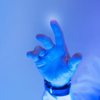 Man touching the futuristic blue screen